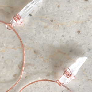 hand-hammered hand wrapped copper hoops with wrapped Quartz crystal