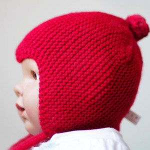 Red knitted baby pilot hat with ties