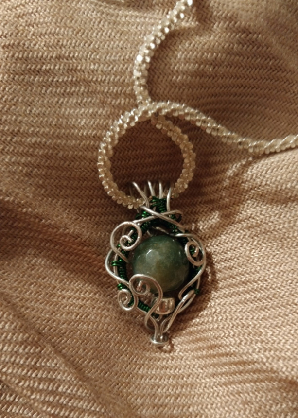 Silver and green glass filigree pendant