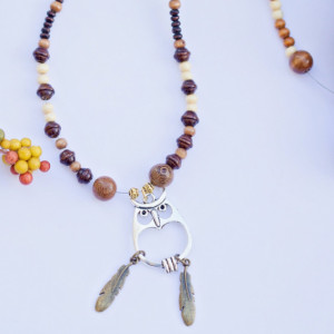 Owl silver pendant charm necklace/Various light and dark wood beads, gold metal spacers and gold feather charms/Under 20 dollars/Nickel free
