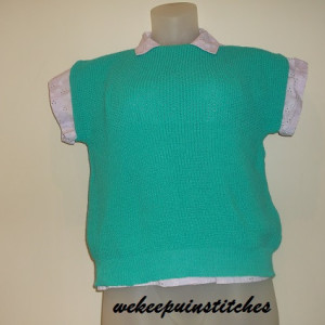 Racing teal sweater with small cap sleeve. Machine knit with hand finished seams. Wear as a causal top in warm weather and layer look