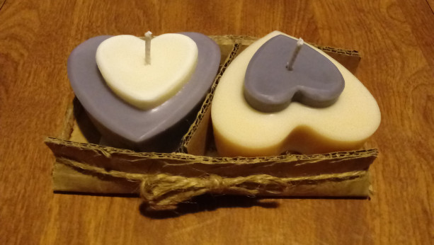 Two 3.5 oz heart-shaped purple and white handmade soy wax candles with inset heart on top