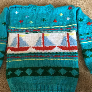 Blue knit sweater with sailboats