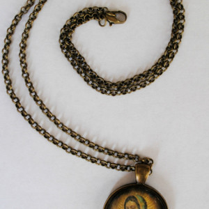 Virgin of Guadalupe circle pendant, brass