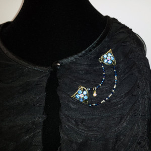Chevron shaped sweater keeper with cobalt blue glass beads and multi-colored rhinestones