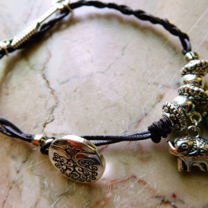 Brown leather braided design bracelet with charms .  #B00213