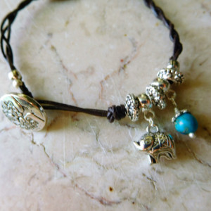 Brown leather braided design bracelet with charms .  #B00213