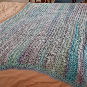 Hand crochet cobble afghan in lavender, blue, turquoise, green.
