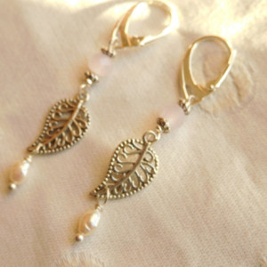 Earrings made with freshwater pearls, silver tone leaf connector, pink crystals beads with silvertone lever back earrings.#E00295