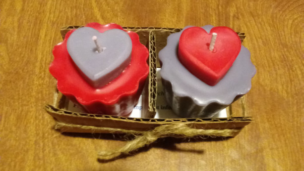 Two 2.5 oz scallop-edged red and purple handmade votive soy wax candles with inset hearts