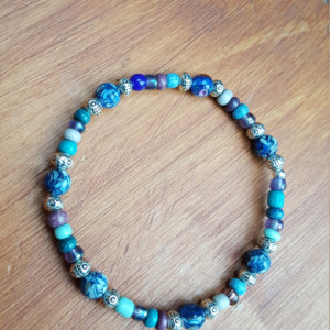 Mixed beads blue, silver, purple and teal colors beads stretchy bracelet.