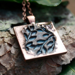 Copper pendant highlighting rustic blue foliage