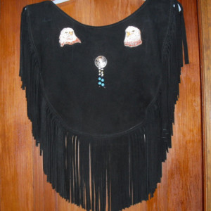Black deer skin leather poncho/caplet. 8" Fringe Size Medium up to approx large. 16” across the shoulders, approx 17” long w/fringe