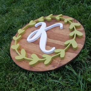 14 inch round wood initial sign with greenery