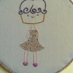Hoop art embroidery. Cupcake girl wearing a dress