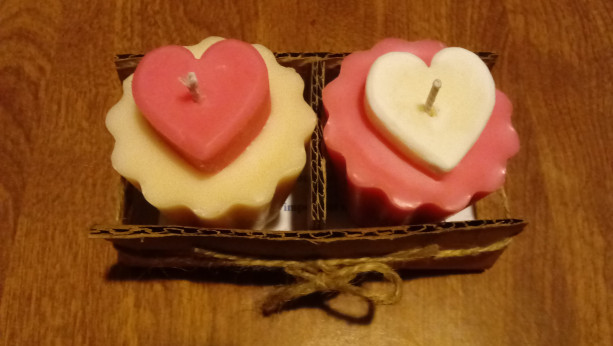 Two 2.5 oz scallop-edged pink and white handmade votive soy wax candles with inset hearts