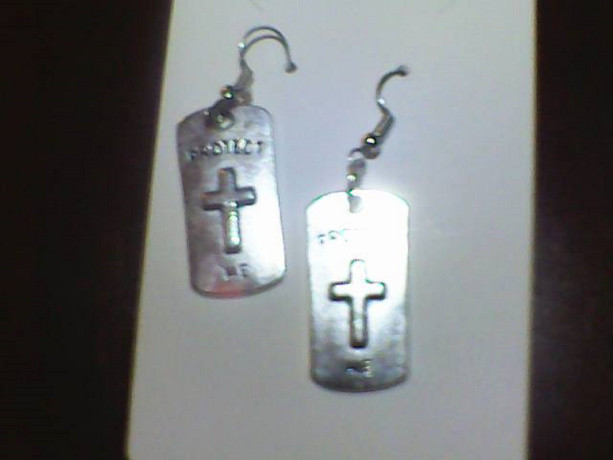 Homemade Double Sided Earring, Protect Me on a Cross. Reverse side Be still and know that I am God. Silver in color.