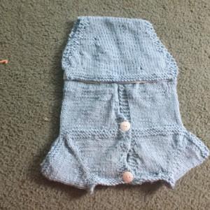 Hand knitted baby onesie