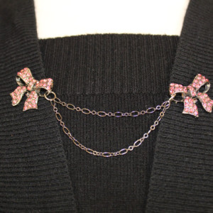 Rose-colored rhinestone bows sweater keeper brooch