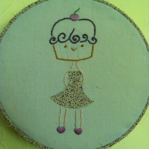 Hoop art embroidery. Cupcake girl wearing a dress