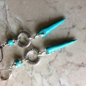 Long earrings made with Turquoise spike beads, silver tone decorative ring and stainless steel lever back earrings. #E00341