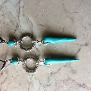 Long earrings made with Turquoise spike beads, silver tone decorative ring and stainless steel lever back earrings. #E00341