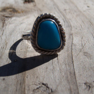 Freeform turquoise cabochon set in a sterling silver setting.