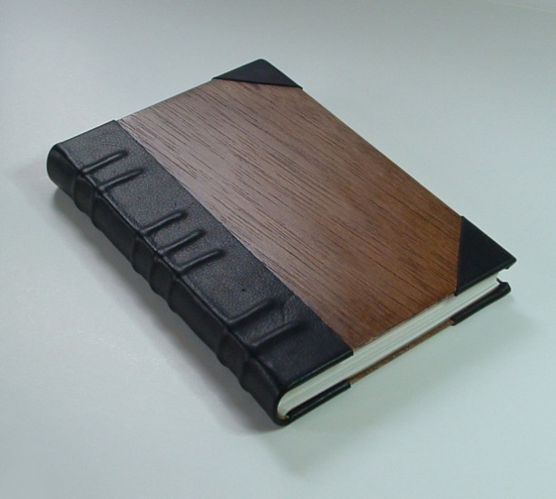 Handmade book bound in leather and wood