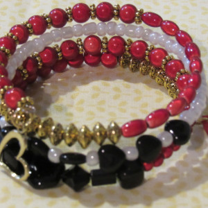 Wire wrapped red and black with gold accent beads bracelet.