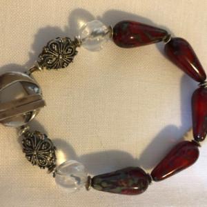 Bracelet with brick red Czech glass beads, clear quartz crystal beads and sterling silver toggle, beads and findings 
