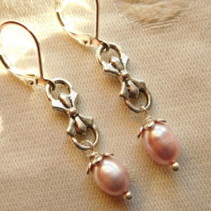 Earrings made with Pink freshwater pearls, silver tone laze connector with silvertone lever back earrings.#E00294
