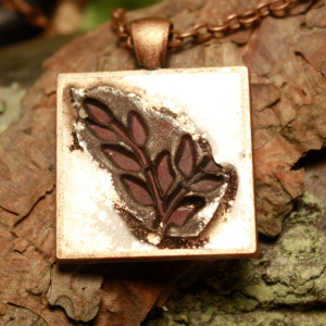 Copper pendant highlighting maroon leaves