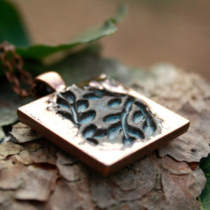 Copper pendant highlighting rustic blue foliage