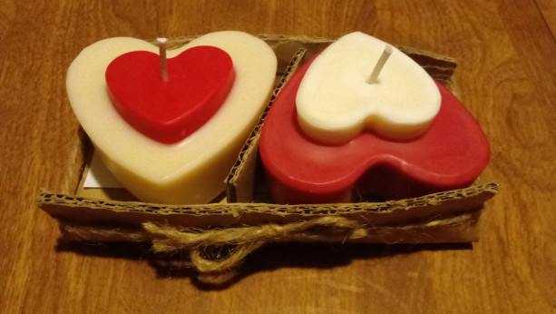 Two 3.5 oz heart-shaped red and white handmade soy wax candles with inset heart on top