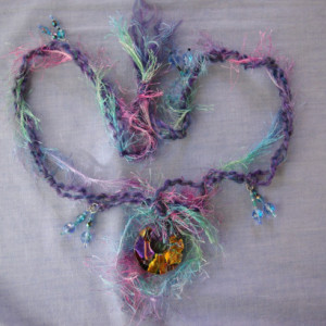 Glorious, dichroic glass pendant wi/ fuzzy yarn string
