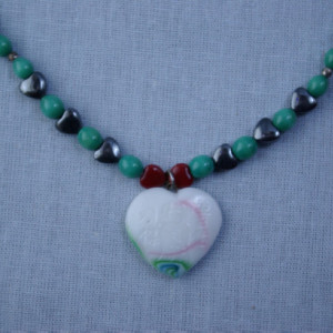 My glass heart sings;  necklace has little red hearts and hemalike hearts.