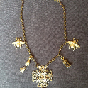 Gold finished brass charm necklace that makes a statement.