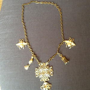 Gold finished brass charm necklace that makes a statement.