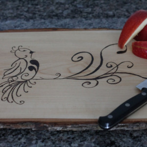 Wooden Cutting board with hand wood burned bird design.