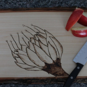 Wooden Cutting board with hand wood burned flower design.
