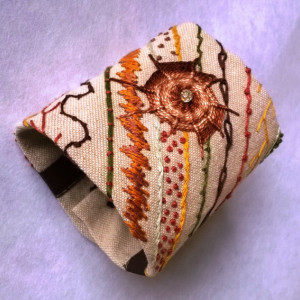Hand Embroidered Cuff in Earth tones on Linen with Vintage Buttons and a Swarovski Crystal