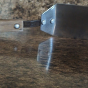 Handmade, sturdy stainless steel blade, riveted pine handle.  This spatula will last.