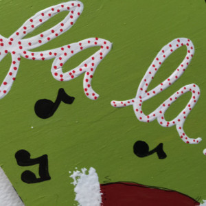 Whimsical Hand Painted Christmas Sign Decoration with Fa La La and Music Notes on Green Background with Santa Hat and Black & White Stripes