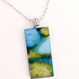 Hand painted blue and green alcohol ink design on glass tile pendant.