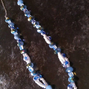 Bluish green glass beads with small blue and white glass beads, 8 inches long with 3 inch silver chain connector and matching earrings.