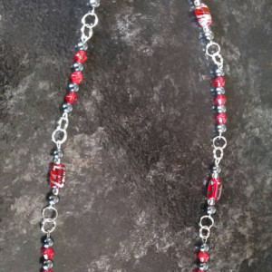Red and gray beaded necklace, 11.5 inches long with matching stainless steel, hypoallergenic earrings.