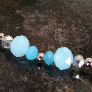 Aqua blue glass beads with small clear beads, 10 inches long, with matching stainless steel hypoallergenic earrings.