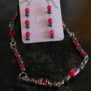 Red and gray beaded necklace, 11.5 inches long with matching stainless steel, hypoallergenic earrings.